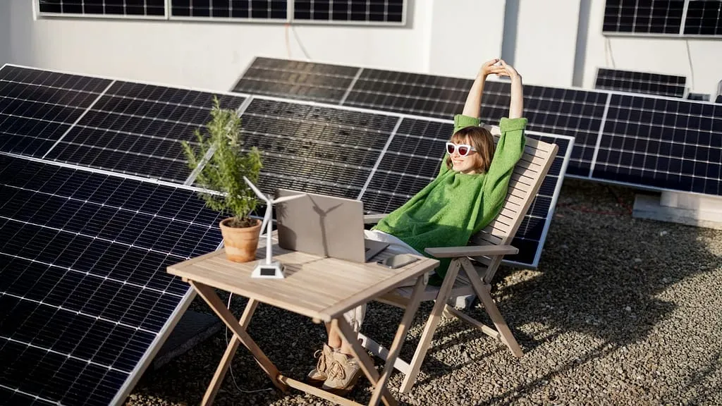 Sitting Down with Solar Panel in Background - Virtual Power Plants: Can You Get Paid To Help The Grid?