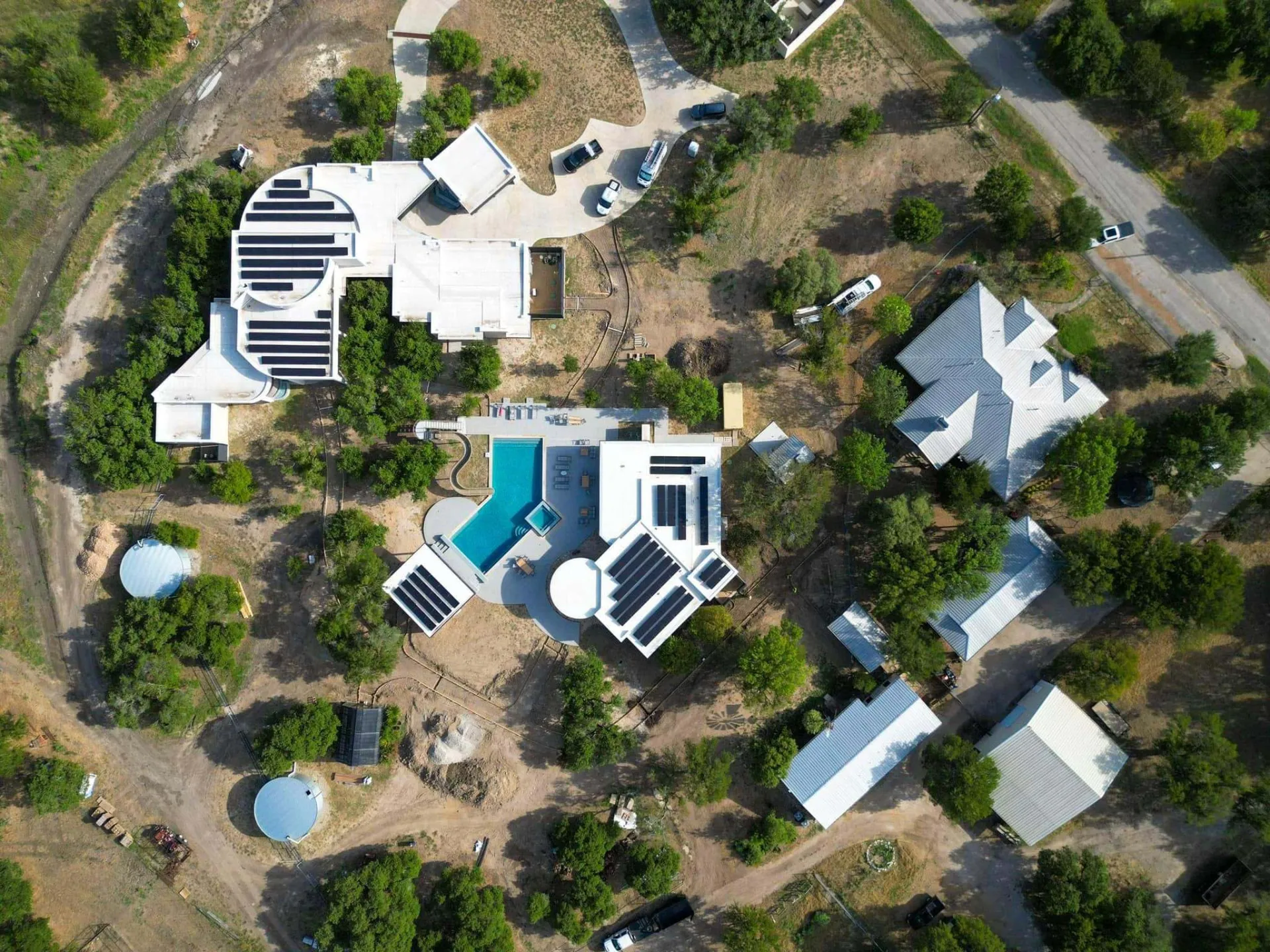 Aerial view of a Texas Hill Country estate with solar panels installed by Good Faith Energy