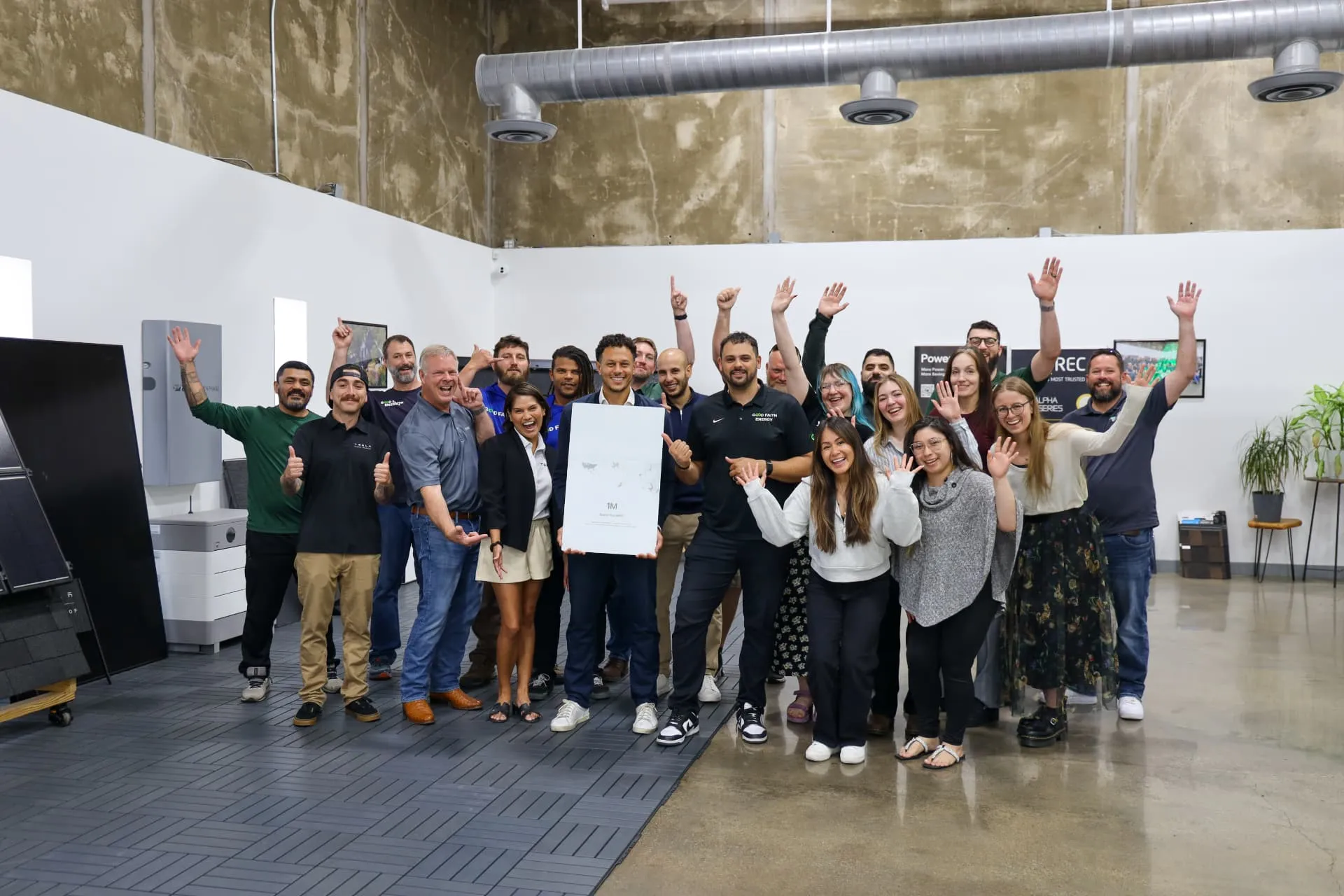 Good Faith Energy team celebrating a partnership milestone in their Texas solar showroom