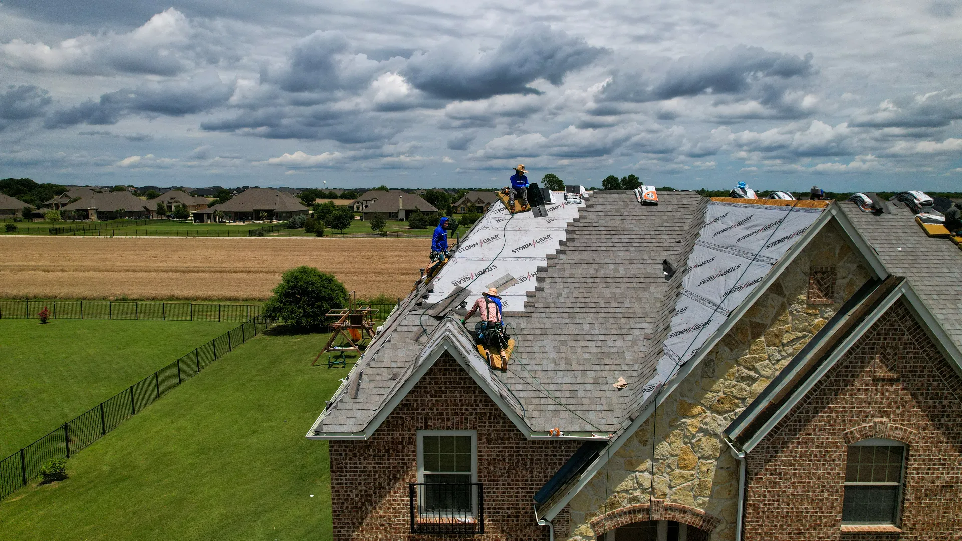 GFE roofing crew installing impact rated shingles on a Texas home after hail damage