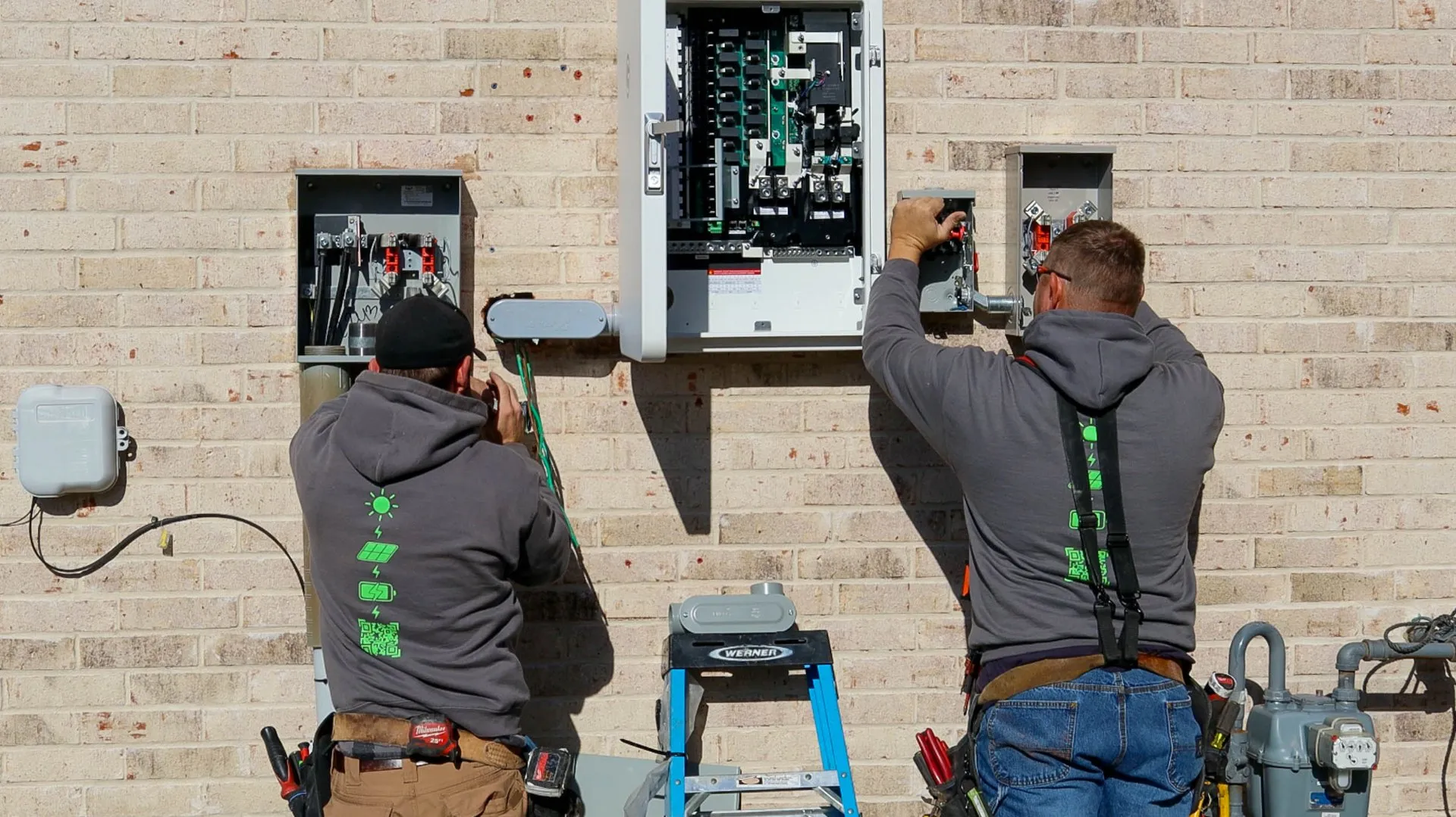 Good Faith Roofing electricians wiring a SPAN smart panel and main service panel in Texas