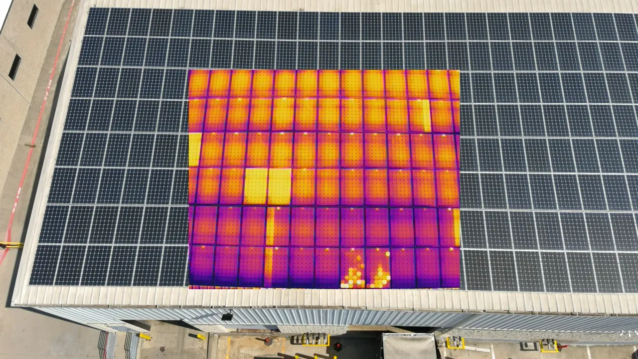 Thermal drone infrared image showing damaged solar panels with hot spots invisible to the naked eye