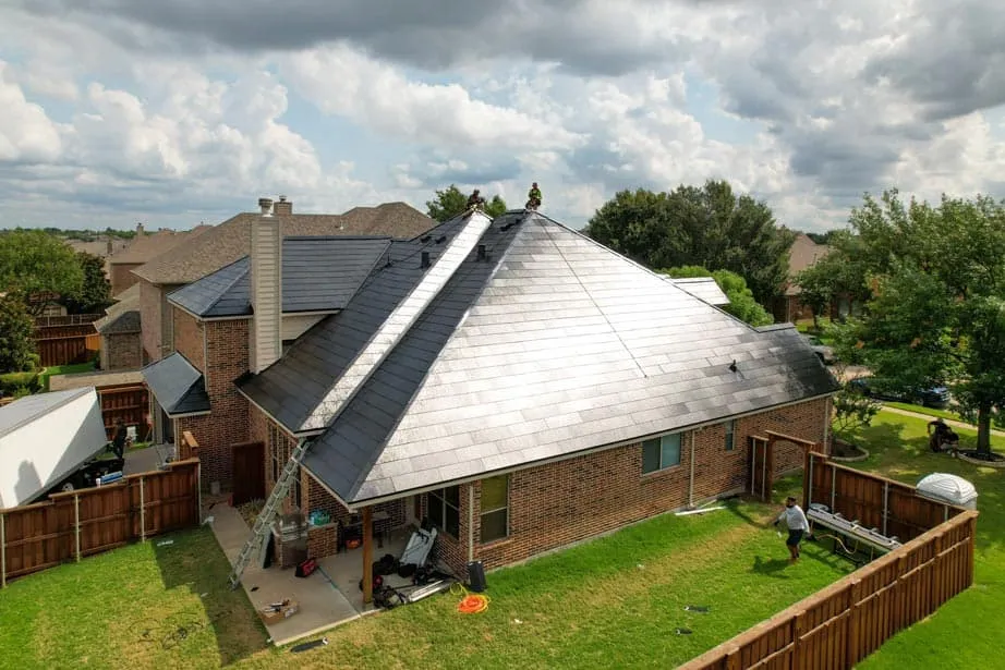 Workers on solar roof - Does Solar Roof Reduce Heat?