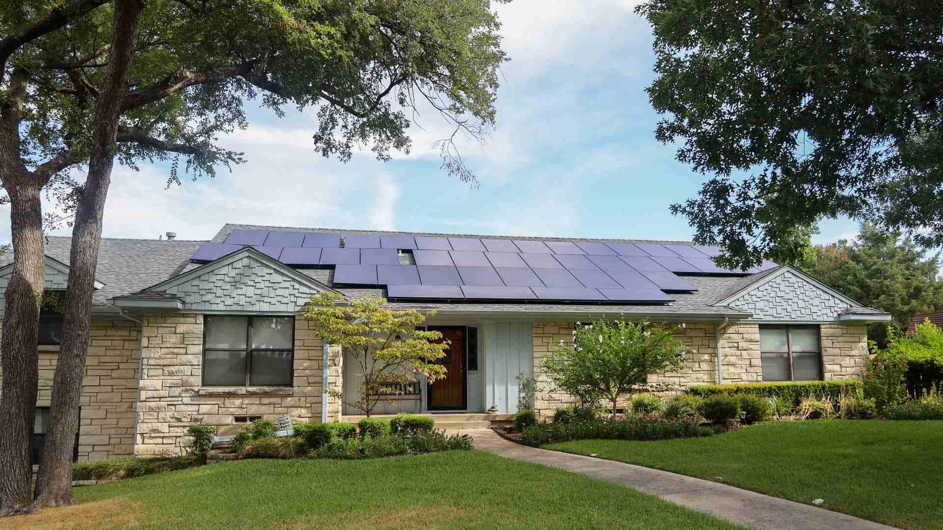 Rooftop solar panels on a brick house, official Good Faith Energy photo